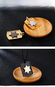 Detail of multi-color stainless steel star dog tag pendant with textured mesh surface