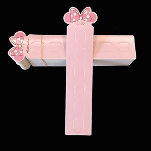 Pink cardboard hair clip display cards with pre-cut slots and bow design detail