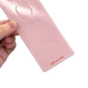 Pink rectangular hair clip display card featuring bracket slots and Made in China stamp