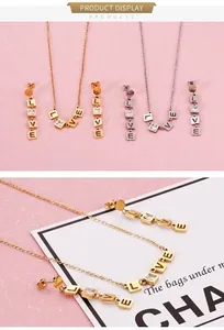 Detailed close-up of gold LOVE square zircon pendant necklace and drop earrings set