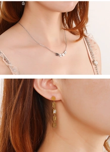 Detailed view of LOVE letter jewelry set with cubic zirconia necklace and earrings
