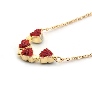 Rose gold magnetic folding four-leaf heart necklace with red stones on white background