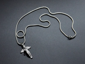 Macro shot of silver titanium steel angel pendant necklace with detailed wings
