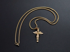 Detailed close-up of golden cherub angel pendant with spread wings on box chain