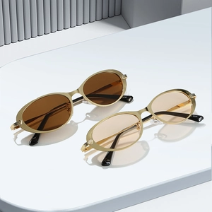 Vintage oval gold metal frame sunglasses with dark brown and light tea lenses for women