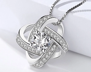 Macro detail of S925 silver spinning four-leaf clover necklace with sparkling zircon stone