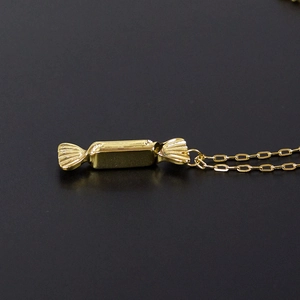 Minimalist gold candy pendant necklace in titanium steel with a sleek long chain design