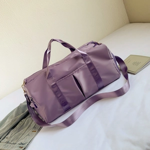 Detail of purple nylon gym bag with wet dry separation and adjustable shoulder strap