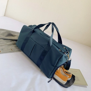 Detail of travel bag showing separate shoe compartment with yellow shoes inside