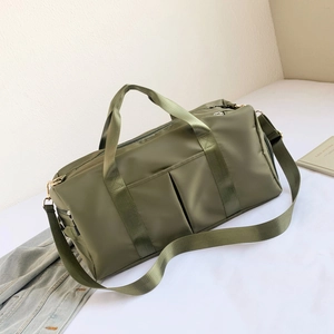 Detailed close-up of army green nylon fitness bag with adjustable shoulder strap and handles