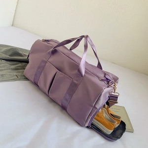 Detail view of purple sports bag with independent shoe compartment and detachable strap