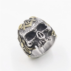 Detailed close-up of a silver and gold Masonic skull ring with G compass emblem