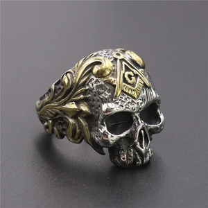 Macro view of men's stainless steel skull ring with masonic square and compass detail