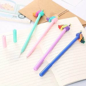 Creative peacock cartoon gel pens in green, pink, purple and blue on a notebook background