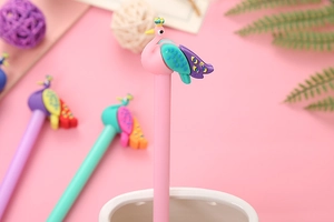 Close-up of cute pink peacock shaped gel pen with creative 3D cartoon crown detail