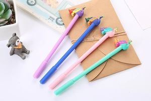 Close-up of four colorful peacock cartoon pens with rubber decor on a desk