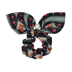 Detailed shot of ethnic pattern scrunchie with large bow and white pearl accent