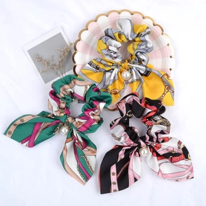 Three-piece silk satin scrunchies with bow, pearl pendants, and chain print pattern