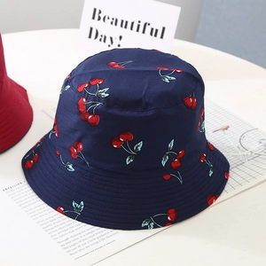 Detail of navy cotton sun hat with cherry pattern and multiple stitching on the brim