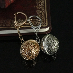 Hollow spherical alloy keychains in gold and silver finish with intricate floral carvings