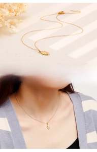 Close-up of golden oval religious portrait pendant with model wearing the vintage necklace