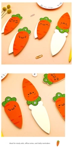 Close-up of carrot-shaped spiral notebook with cute expressions on orange background