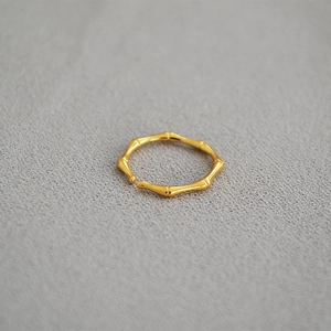 Detail shot of a minimalist gold-plated brass bamboo joint ring with adjustable opening