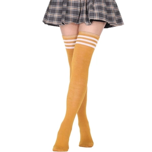 Detail of ginger yellow over-knee high socks with triple white athletic stripes