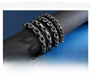 Macro shot of stainless steel punk skull chain bracelets with heavy metal engraving details