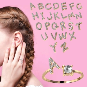 Collage of 26 alphabet rings with gold plating and sparkling zircon stone inlays