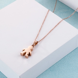 Cute boy silhouette pendant necklace in rose gold finish on a white geometric stand