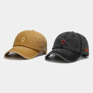 Detail of vintage washed cotton baseball caps with C embroidery and 1999 side stitching
