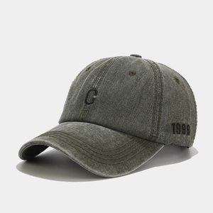 Detail of vintage washed cotton baseball cap with C embroidery and 1999 side stitching