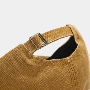 Macro shot of washed cotton baseball cap with adjustable metal buckle and stitching