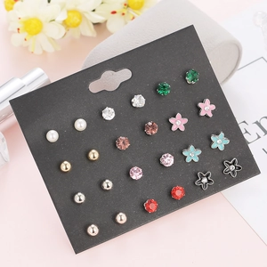 Detail of 12 pairs of mixed stud earrings with pearls and colorful crystals on card