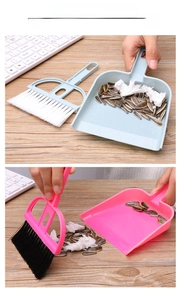 Mini desktop broom and dustpan set cleaning keyboard and crumbs on wooden surface