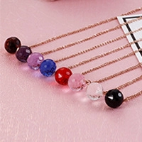Macro view of multi-colored spherical bead pendants with rose gold necklace chains