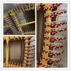 Batch of gold bridal headbands with red roses and pearls in warehouse storage