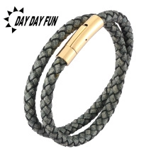 Close-up of a dark grey double-strand braided leather bracelet with golden magnetic clasp