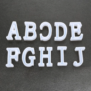 Detailed top view of translucent silicone resin molds for A to J uppercase letters