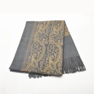 Detail of gray cashmere scarf with golden paisley embroidery and fringed edges