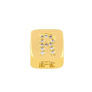 Macro view of gold plated alphabet R charm with sparkling cubic zirconia stones