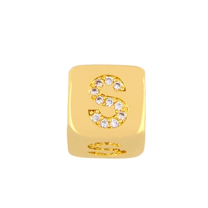 Detailed close-up of a gold-plated cube charm with a diamond-set letter S design