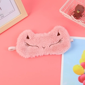 Close-up of pink plush cat sleep mask with soft faux fur texture and embroidered eyes