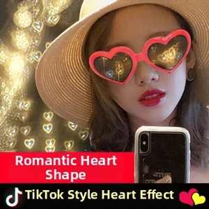 Close-up of red heart-shaped frames with clear lenses shown on model during a party