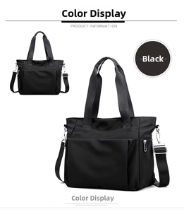 Detail view of black nylon tote bag featuring durable handles with text and side pocket
