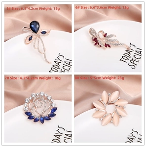 Detail of elegant crystal and pearl brooches in four distinct floral and drop designs