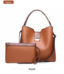 Detail of brown two-piece tote bag set with snakeskin texture handles and metal buckle