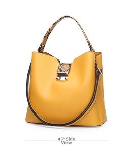 45-degree side view of a yellow trapezoid handbag with snakeskin handles and gold lock