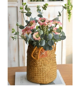 Detailed close-up of natural seagrass woven basket with leather patch and rope handles